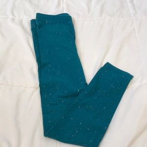 Teal leggings with holographic speckles throughout